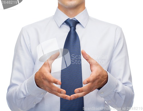 Image of buisnessman holding something in his hands