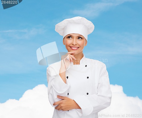 Image of smiling female chef dreaming