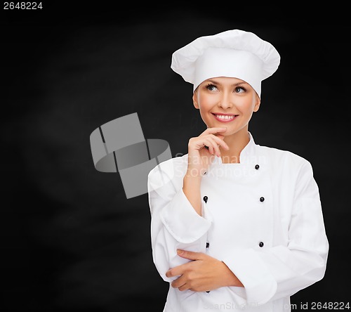 Image of smiling female chef dreaming