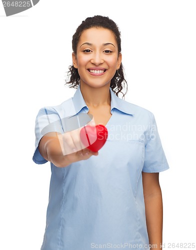 Image of smiling female doctor or nurse with heart