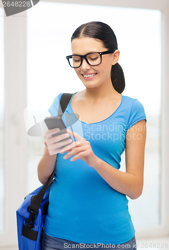 Image of smiling female student with smartphone and bag