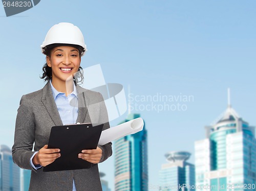 Image of businesswoman in white helmet with clipboard