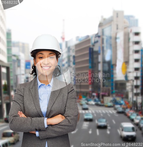 Image of businesswoman in white helmet with crossed arms