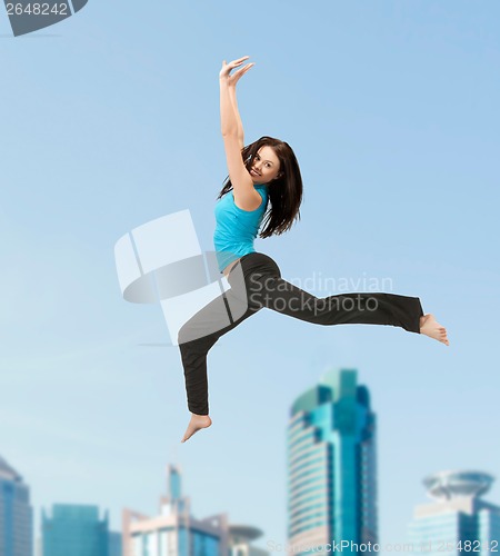 Image of sporty woman jumping in sportswear