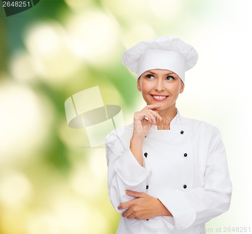 Image of smiling female chef dreaming