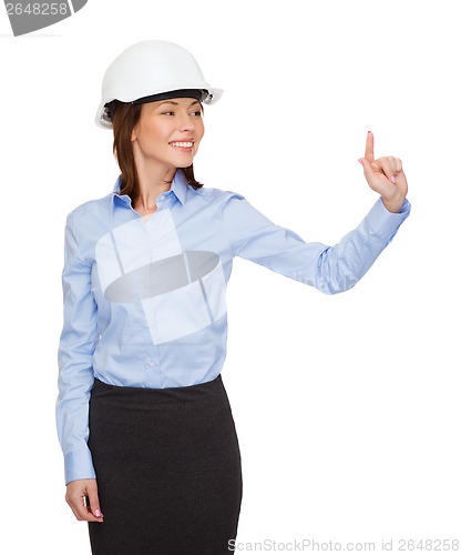 Image of young smiling businesswoman in white helmet