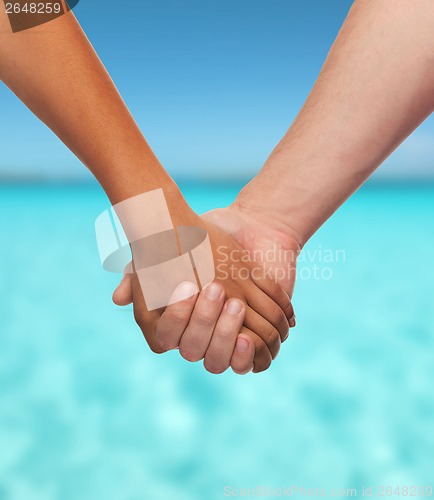 Image of woman and man holding hands