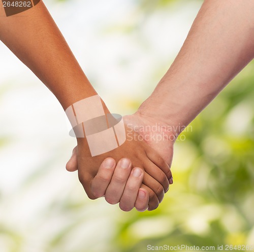 Image of woman and man holding hands
