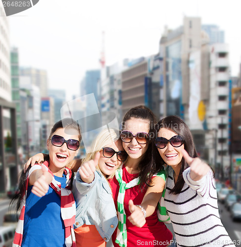 Image of teenage girls or young women showing thumbs up