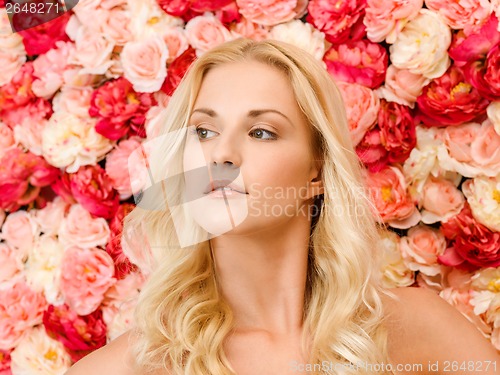 Image of beautiful woman and background full of roses