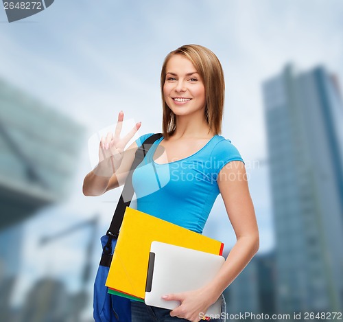 Image of female student with bag, tablet pc and folders