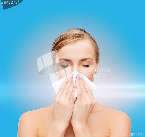 Image of beautiful woman with paper tissue