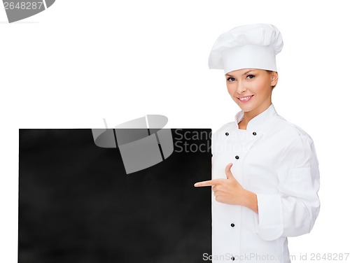 Image of smiling female chef with white blank board