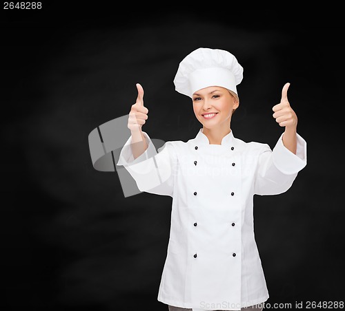 Image of smiling female chef showing thumbs up