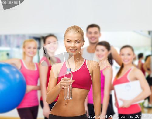 Image of smiling woman with bottle of water