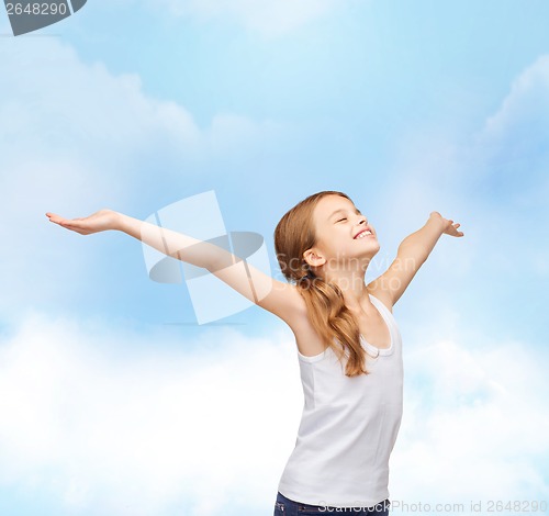 Image of smiling teenage girl with raised hands