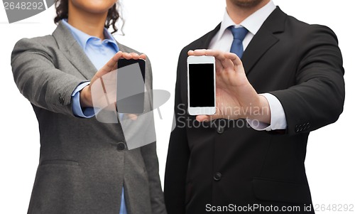 Image of businessman and businesswoman with smartphones