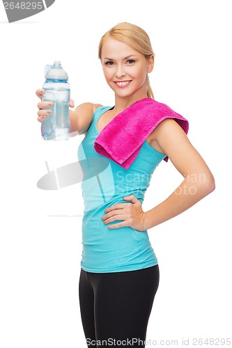 Image of sporty woman with towel and watel bottle