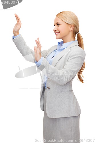 Image of smiling businesswoman pointing to something
