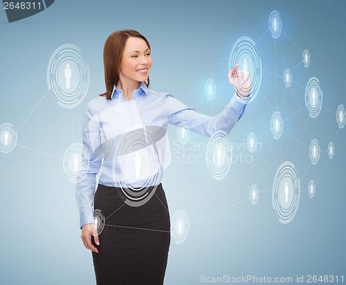 Image of smiling businesswoman working with virtual screen