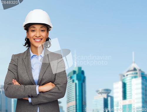 Image of businesswoman in white helmet with crossed arms