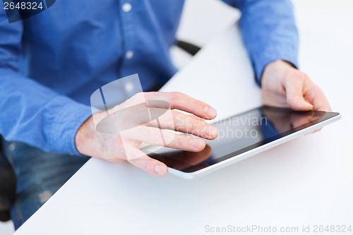 Image of close up of male hands working with tablet pc