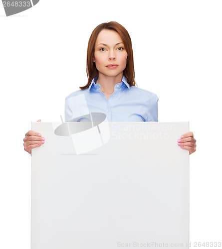 Image of young calm businesswoman with white blank board