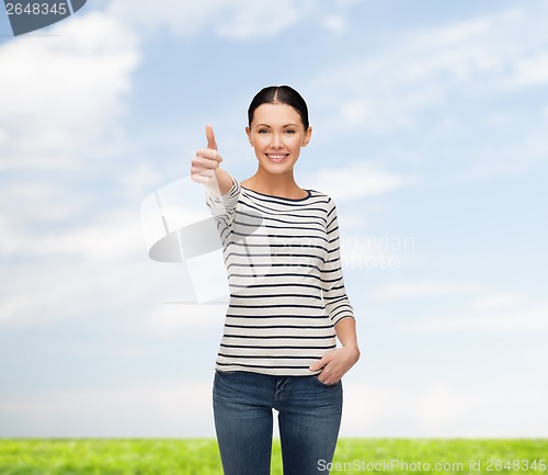 Image of smiling girl in casual clother showing thumbs up
