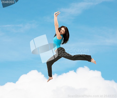 Image of sporty woman jumping in sportswear