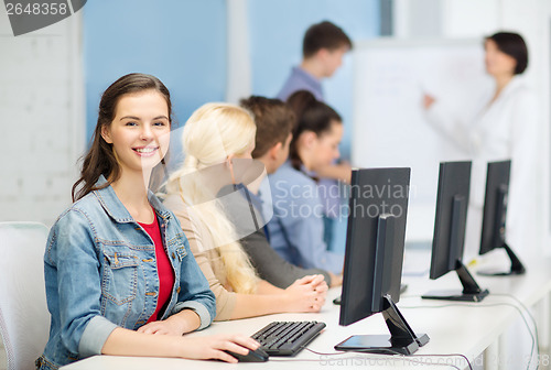 Image of smiling teenage girl with classmates and teacher