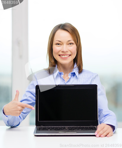 Image of businesswoman with blank black laptop screen