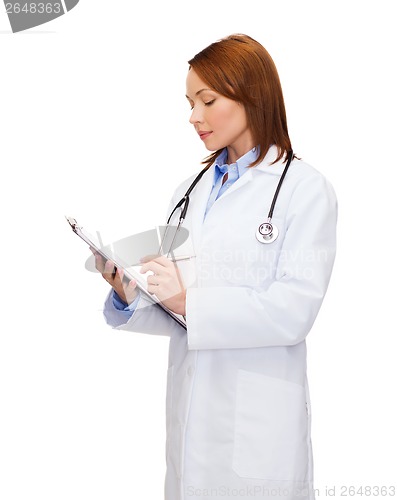 Image of smiling female doctor with clipboard