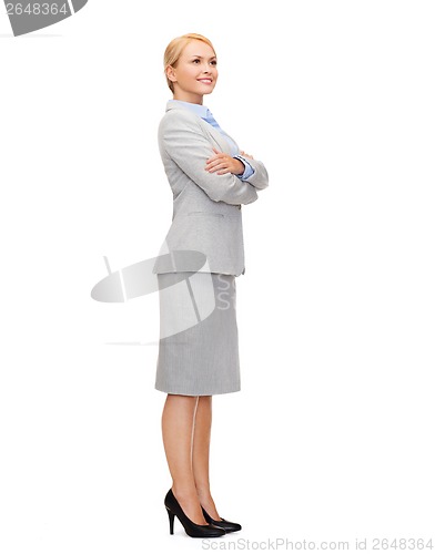 Image of smiling businesswoman with crossed arms