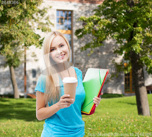 Image of smiling student with folders