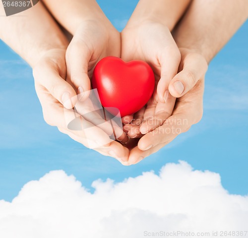 Image of woman and man hands with heart