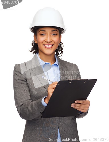 Image of businesswoman in white helmet with clipboard