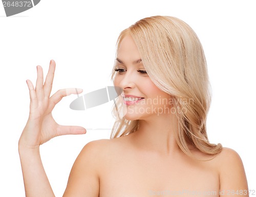 Image of smiling woman holding something imaginary