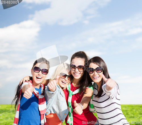 Image of teenage girls or young women showing thumbs up