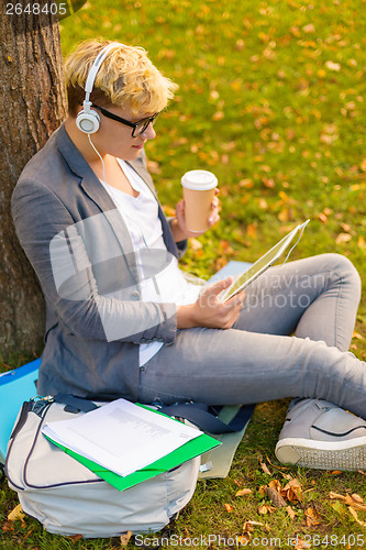 Image of smiling male student in eyeglasses with tablet pc