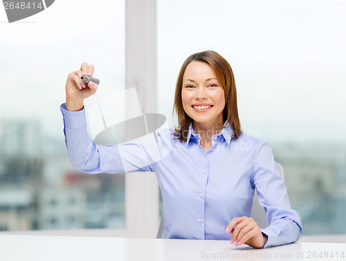 Image of businesswoman writing something in the air