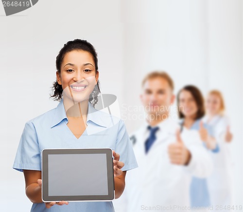 Image of smiling female doctor or nurse with tablet pc