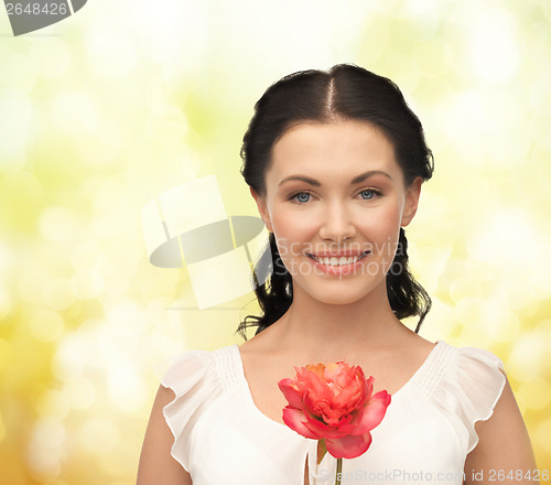 Image of young and beautiful woman with flower