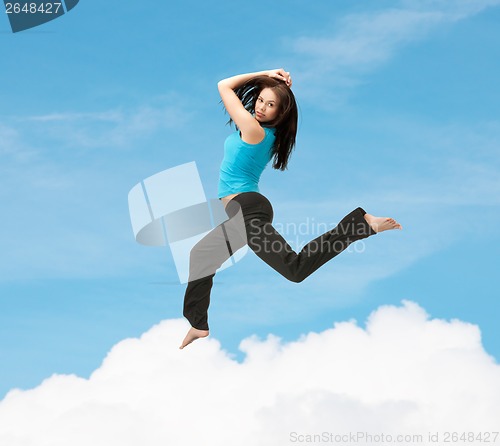 Image of sporty woman jumping in sportswear