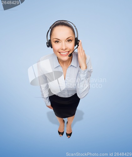 Image of friendly female helpline operator with headphones