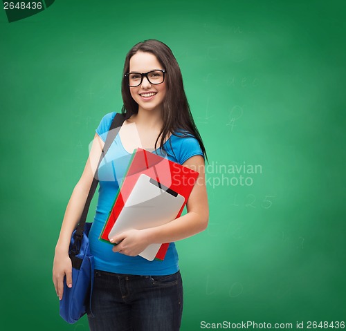 Image of smiling student with bag, folders and tablet pc