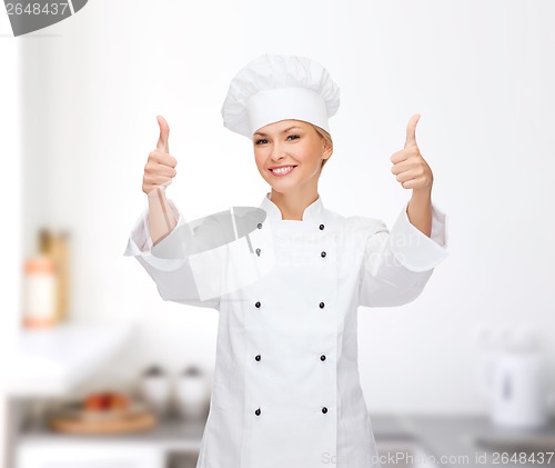 Image of smiling female chef showing thumbs up