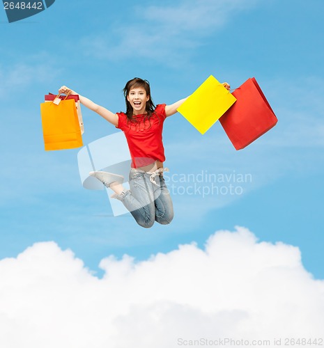 Image of excited girl with shopping bags