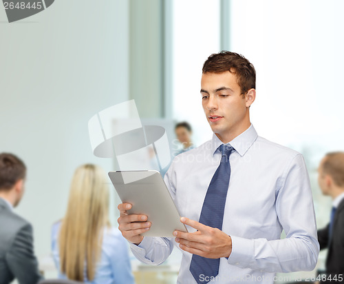 Image of buisnessman with tablet pc at office