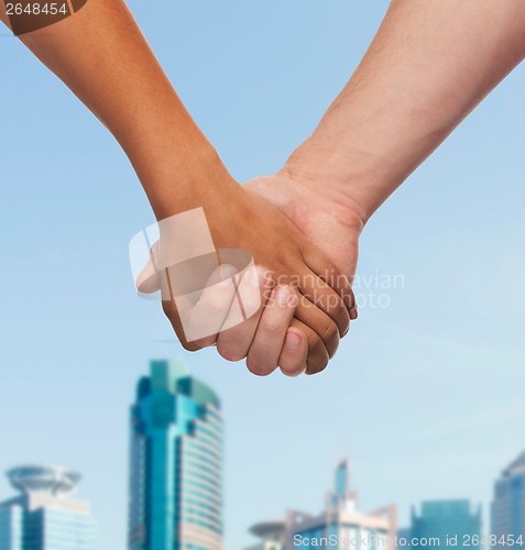 Image of woman and man holding hands