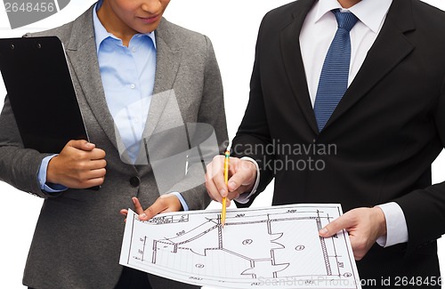 Image of businesspeople with clipboard and blueprint